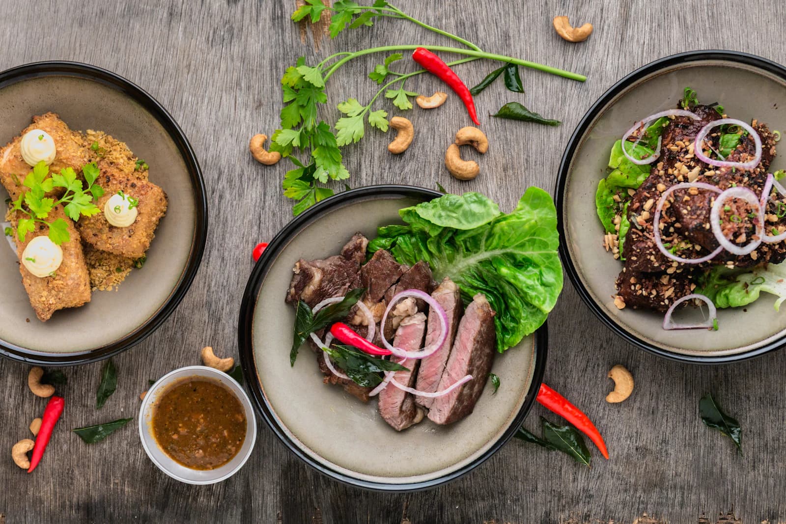 Three plated dishes photographed from above during a menu review