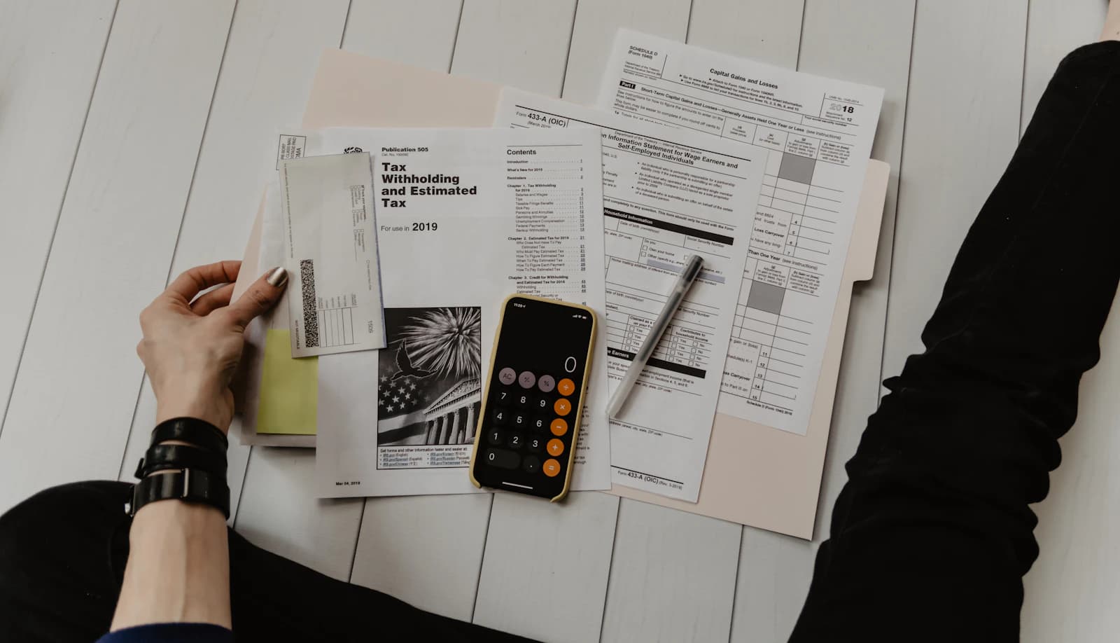 Calculator, invoices and receipts laid out for a margin review