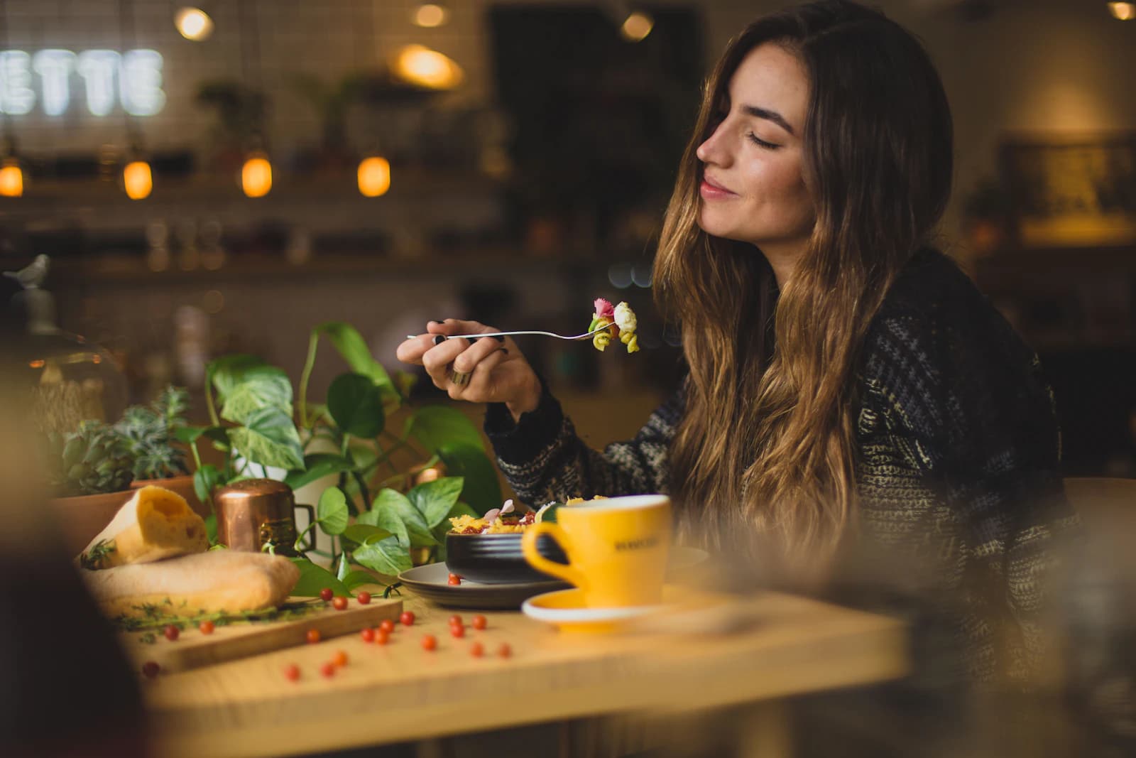 Guest enjoying a meal in warm restaurant lighting